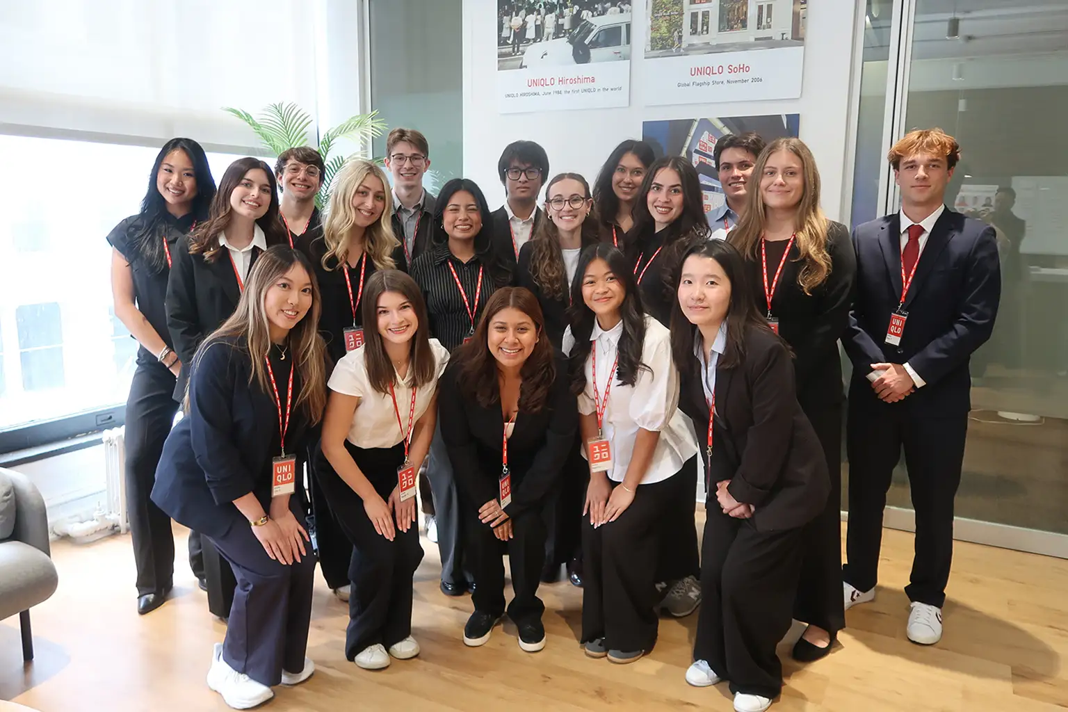 A group of UNIQLO store team members in matching uniforms working together on the shop floor